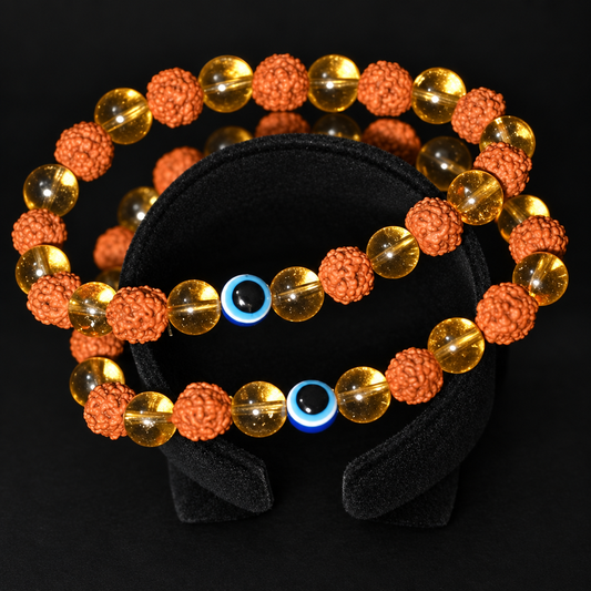 Energized Mantra beaded accessory with orange textured beads, golden-toned translucent beads and blue eye-style bead details.