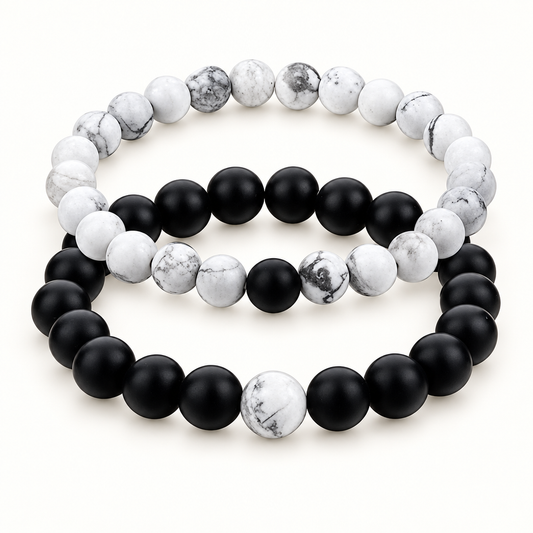 Black and white bead bracelets with white beads showing grey marbling.